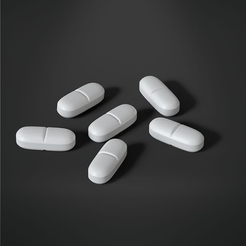 Six oval white medication tablets